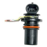 A black automotive sensor component with a three-pin electrical connector, a metal clip, and an orange ring, isolated on a white background.